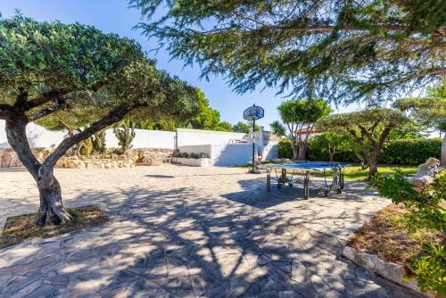 a picnic table in a park with a tree at Mas Vilet by Unik Vacation in Catllar