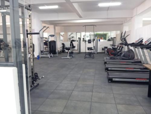 a gym with several treadmills and machines at Furnished two bedroom apartment with swimming pool fully equipped gym children playground ample parking space and unbeatable scenic city views in Nairobi