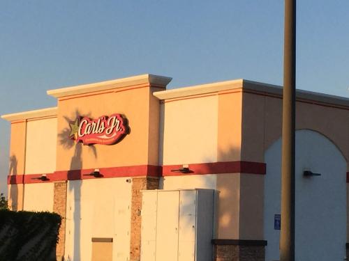 a building with a sign on the side of it at California Inn Hotel and Suites Adelanto US 395 in Adelanto