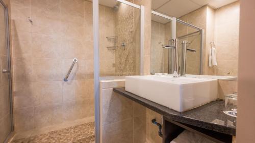 a bathroom with a sink and a shower at ANEW Hotel Hatfield Pretoria in Pretoria