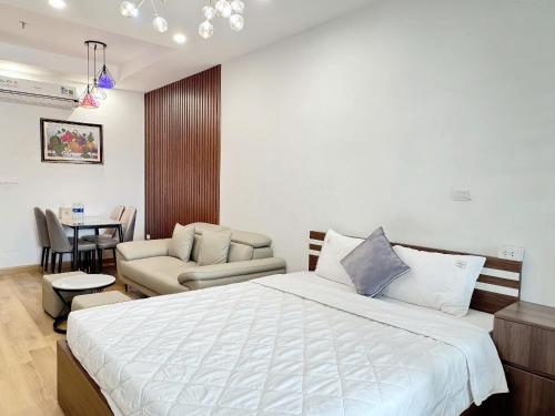 a bedroom with a bed and a living room at Seafront Apartment TMS Quy Nhơn in Quy Nhon