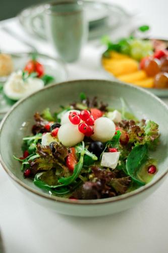 a salad in a bowl on a table at Hotel & Restauracja Timberland in Orzesze