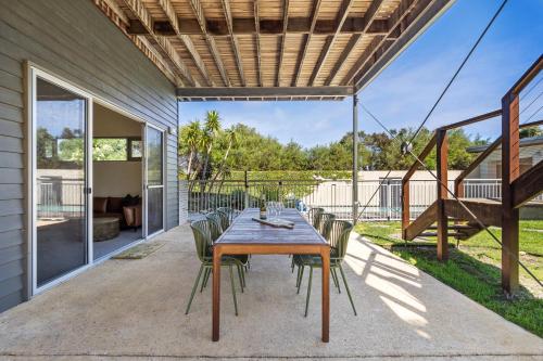 a patio with a wooden table and chairs at Seabreeze Escape, Coastal Stay in Gnarabup