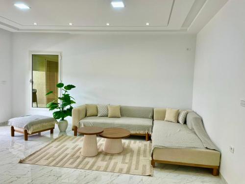 a living room with a couch and a table at Dar kenza in Ouled Yaneg