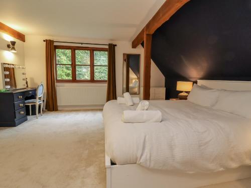 a bedroom with two beds and a large window at Hedgerose in Goodleigh