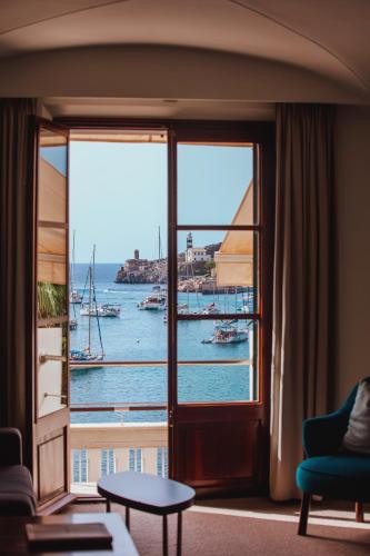a room with a window with a view of the water at Hotel Esplendido in Port de Soller