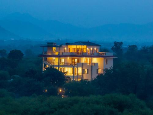 a house sitting on top of a hill at night at Dilip Niwas in Udaipur