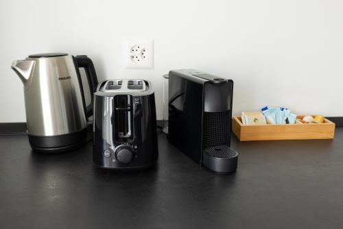 two coffins and a coffee maker sitting on a counter at Cityview Balcony - in the heart of Biel in Biel
