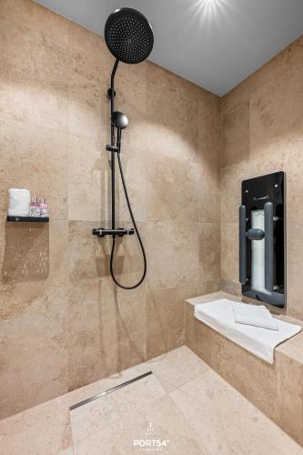 a bathroom with a shower with a shower head at Seaside Suite List auf Sylt in List