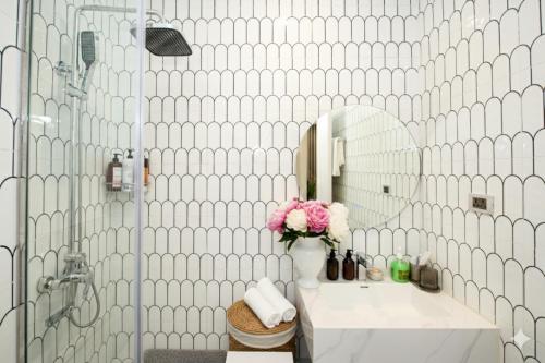 a bathroom with a sink and a mirror at Nagomi Apartment in Hanoi