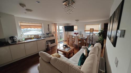 a living room with a couch and a dining room at The Bridge in Dartford