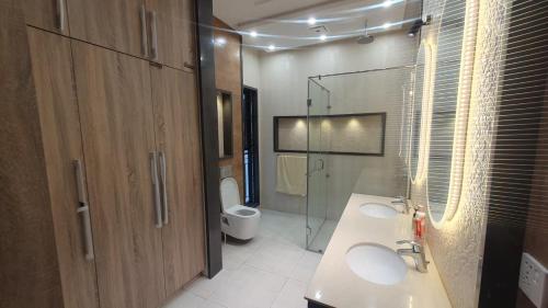 a bathroom with two sinks and a glass shower at AA Loft in Lahore