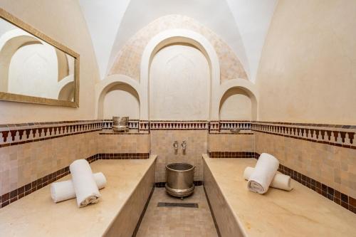 a large bathroom with two sinks and a mirror at Riad Olma in Marrakech