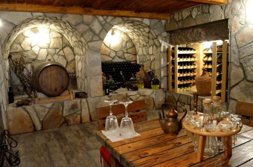 a wine tasting room with a large stone wall at Country House Djurisic in Virpazar