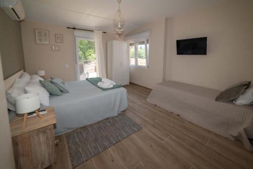 a large bedroom with a bed and a window at Finca Avellaneda in Navahonda