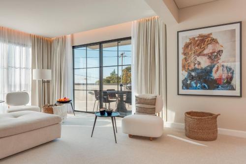 a living room with a couch and a chair and a table at Villa Mangoni - Brand New Luxury Villa in Funchal