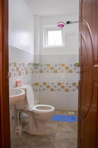 a bathroom with a toilet and a sink at K&K Stays in Nakuru