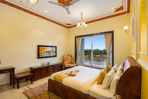 a bedroom with a large bed and a window at ELIVAAS LakeMount 2-BHK Getaway with Private Pool, Open-Air Gazebo & Terrace At Fatehsagar Lake in Udaipur