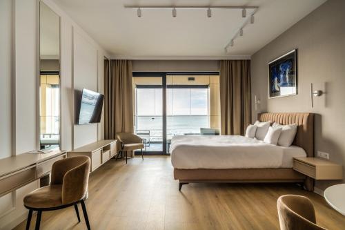 a hotel room with a bed and a view of the ocean at Baltic View Resort & SPA, a member of Radisson Individuals in Międzyzdroje