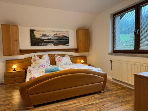 a bedroom with a bed with two lamps on it at Haus am Erzbach - Ferienwohnung mitten in der Natur in Eisenerz