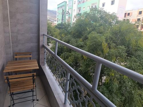 a balcony with a wooden table and a bench at El rincón tranquilo in Tetouan