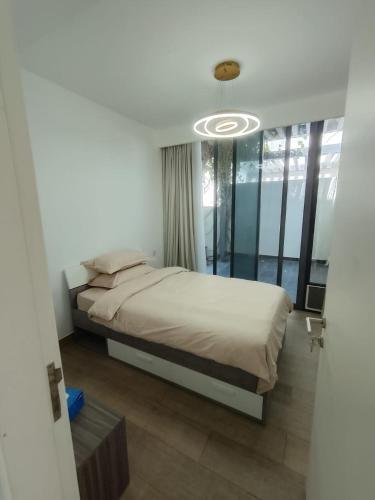 a bedroom with a bed and a large window at Dubai Hills Mahek Holiday Villa in Dubai