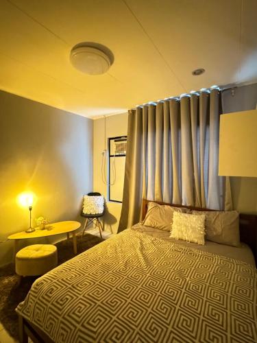 a bedroom with a bed with a blue curtain at Matthews Home Cebu-Casa Uno in Cebu City
