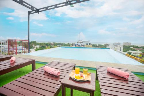 a table with a plate of food on top of a pool at Golden Daisy Hotel Phu Quoc in Phu Quoc