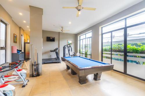 a pool table in a room with a view of a swimming pool at Golden Daisy Hotel Phu Quoc in Phu Quoc