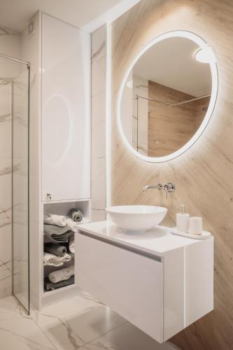 a bathroom with a white sink and a mirror at Trzy Wyspy Barlinek in Barlinek