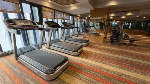a row of treadmills in a gym with a row of treadms at The Signature Hotel Nha Trang in Nha Trang