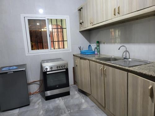 a kitchen with a sink and a stove at Tish home away from home in Safim