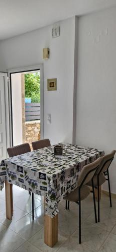 a dining room table with a table cloth on it at Το πετρινο σπιτι in Kámpos