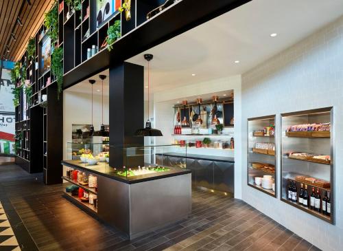 a restaurant with a counter with food on display at citizenM Seattle Pioneer Square in Seattle