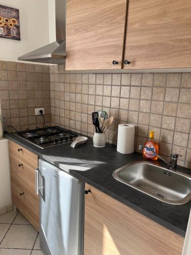 a kitchen with a sink and a stove at pied a terre due passi dal porto in Livorno