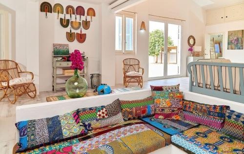 a living room with a bunch of pillows on a couch at Casa Codol in Illes Balears
