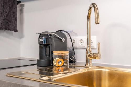 a kitchen counter with a sink and a coffee maker at City center!AC,free parking,terasse in Pärnu