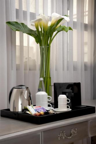 a tray with a vase with flowers on a table at NH Boulevard del Río Cali in Cali