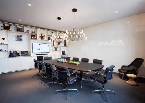 a conference room with a large table and chairs at citizenM Copenhagen Radhuspladsen in Copenhagen