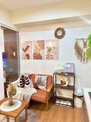 a living room with a couch and a table at Azure Staycation by Jeric in Manila