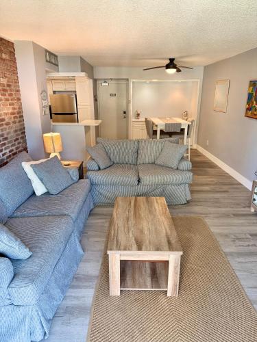 a living room with two couches and a coffee table at Beach Front Condo In Paradise Marco Island in Marco Island