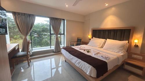 Ένα ή περισσότερα κρεβάτια σε δωμάτιο στο Hotel Suvidha Residency