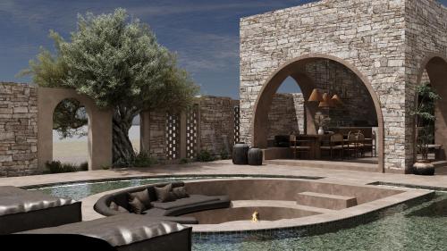 a patio with a fire pit in the middle of a pool at 12 Islands Villas in Kolimbia