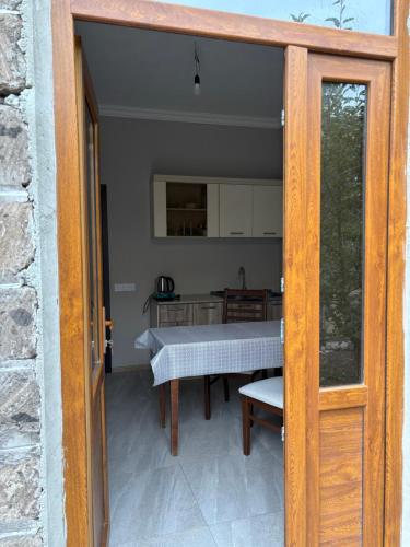 an open door to a patio with a table at Gyumri Home in Gyumri