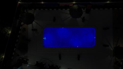 a blue television screen on a wall in the dark at Wayma Paradise Resort in Jambiani