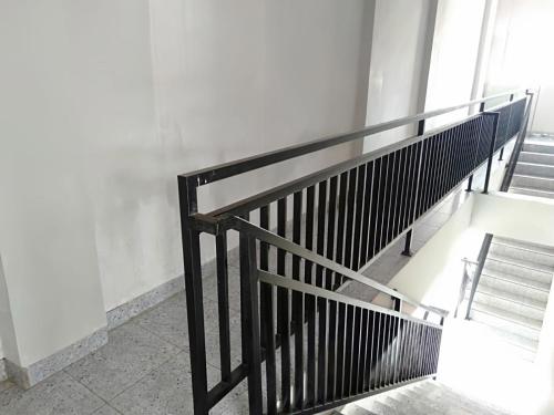 a staircase with a metal railing and a bench at Dancenter Z Hotel in Bandar Lampung