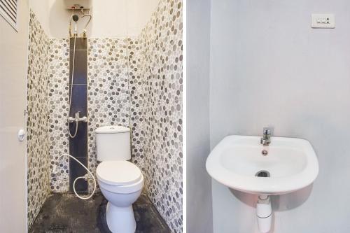 a bathroom with a toilet and a sink at Dancenter Z Hotel in Bandar Lampung