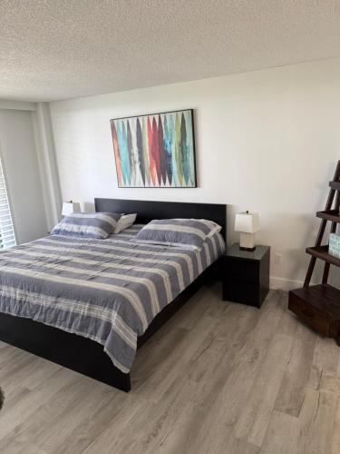 a bedroom with a bed and a painting on the wall at Beach Front Condo In Paradise Marco Island in Marco Island