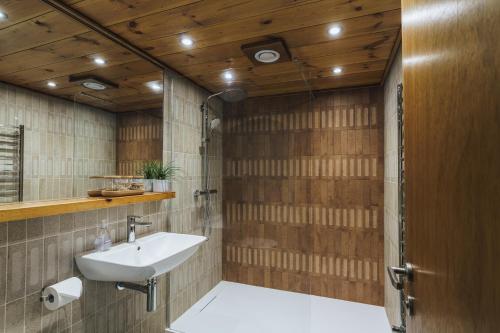 a bathroom with a sink and a mirror at The Hideaway at Yew Trees, Ullswater in Watermillock