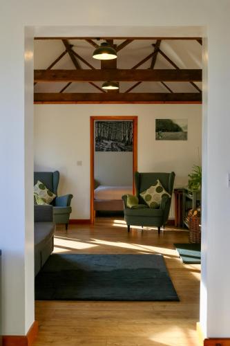a living room with two couches and a rug at Tranquil and cosy cottage on the Somerset Levels in Bridgwater